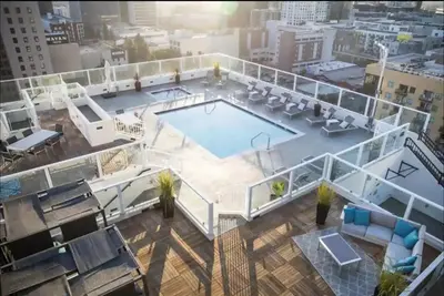 an overhead view of a swimming pool on top of a building at Luxury 2BR in DTLA w Jacuzzi & Rooftop Views in Los Angeles
