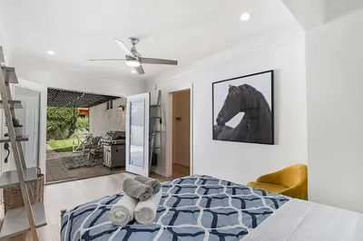 a bedroom with a bed with a horse picture on the wall at Updated 3-Bedroom LA Home with Backyard, BBQ & Family-Friendly Amenities in Los Angeles