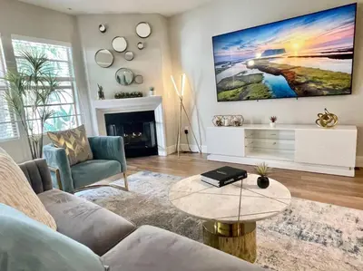 a living room with a couch and a table at Lux One Bedroom Condo with Garden View in Los Angeles