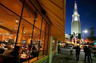 a building with a clock tower in the background at Lux One Bedroom Condo with Garden View in Los Angeles
