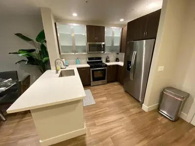 a kitchen with a white counter and a refrigerator at Lux One Bedroom Condo with Garden View in Los Angeles