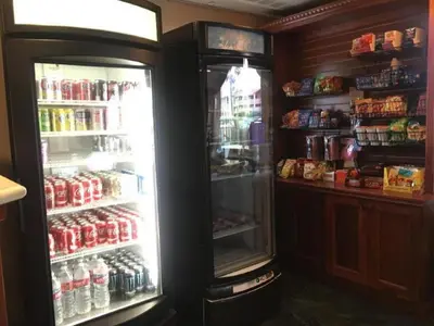 a refrigerator with its door open in a store at Folk Inn Ontario Airport in Racimo
