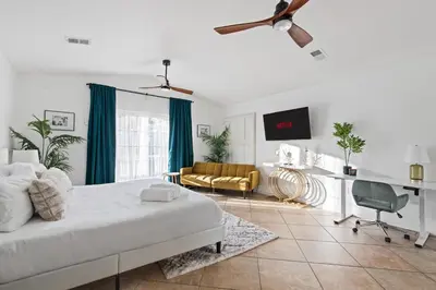 a white bedroom with a bed and a couch at Modern Oasis with Pool & Jacuzzi near Universal Studios in Los Angeles
