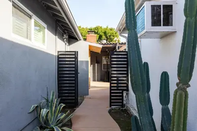 a side walk with a cactus next to a house at Modern Oasis with Pool & Jacuzzi near Universal Studios in Los Angeles