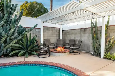a patio with a fire pit next to a swimming pool at Modern Oasis with Pool & Jacuzzi near Universal Studios in Los Angeles