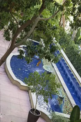 a swimming pool with trees and plants in it at 1 Bedroom XL Condo with King bed, Garden View, Parking Included in Los Angeles