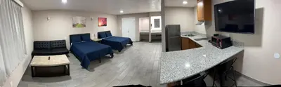 a hospital room with blue chairs and a counter at Lone Oak Studio Suites in Bakersfield