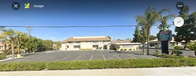 a parking lot in front of a building at Lone Oak Studio Suites in Bakersfield