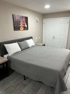 a bedroom with a large bed in a room at Lone Oak Studio Suites in Bakersfield