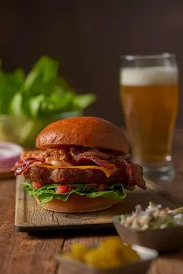 a sandwich on a table with a glass of beer at Hyatt House LAX Manhattan Beach in El Segundo
