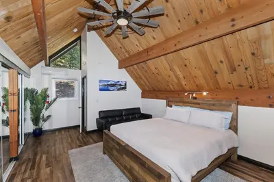 a bedroom with a bed and a ceiling fan at Cocos Cottage Getaway Running Springs in Running Springs