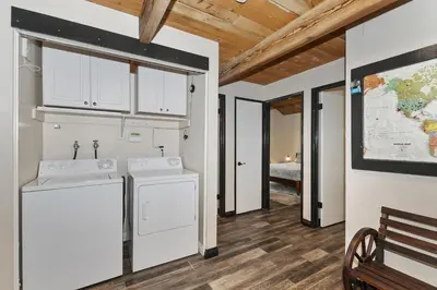 a kitchen with white appliances and a map on the wall at Cocos Cottage Getaway Running Springs in Running Springs