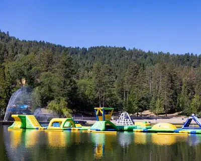 a group of inflatable play structures on a lake at Cocos Cottage Getaway Running Springs in Running Springs