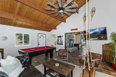 a living room with a pool table and a ceiling fan at Cocos Cottage Getaway Running Springs in Running Springs