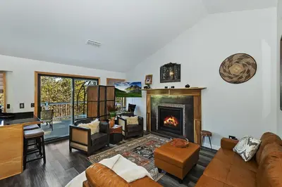 a living room with a couch and a fireplace at Lake Arrowhead Grass Valley Cabin in Lake Arrowhead
