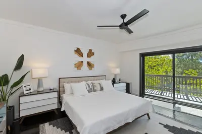 a white bedroom with a bed and a window at North Bay Chalet Views in Lake Arrowhead