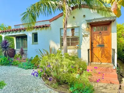 a house with a palm tree and a door at Prime West Los Angeles 4 Bedroom 2 Bathroom House in Los Angeles
