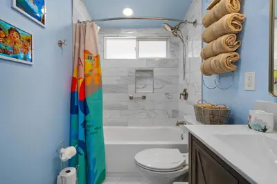 a bathroom with a tub and a toilet and a sink at Pixar Pier by OC Adventure Homes in Anaheim