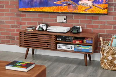 a wooden table with consoles on top of it at Pixar Pier by OC Adventure Homes in Anaheim