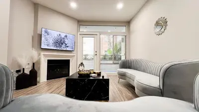 a living room with a couch and a fireplace at Modern Apartment in Trendy Area in Los Angeles