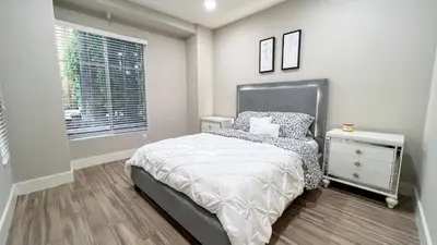 a small bedroom with a bed and a window at Modern Apartment in Trendy Area in Los Angeles