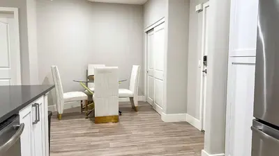 a dining room with a table and white chairs at Modern Apartment in Trendy Area in Los Angeles