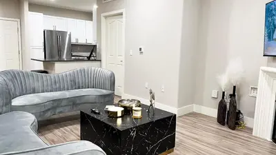 a living room with two couches and a table at Modern Apartment in Trendy Area in Los Angeles