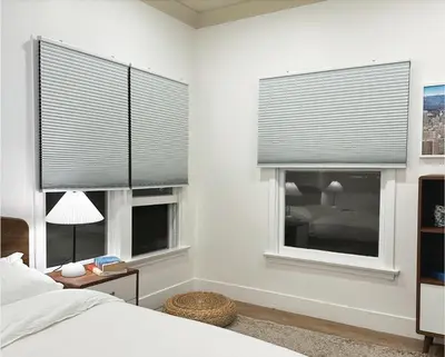a bedroom with two windows with grey blinds at Broskin apartments in Los Angeles