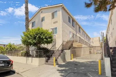 a building with stairs and a tree in front of it at Central Hollywood Apartment in Los Angeles