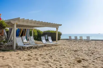 a group of chairs on a beach with a gazebo at Aqualina Best View in Malibu by Stay Awhile Villas in Malibu