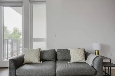 a gray couch in a living room with a window at Blueground Pasadena gym elev near bars LAX-1231 in Los Angeles