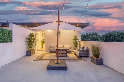 a patio with a table and an umbrella at LA Cityscapes in Los Angeles