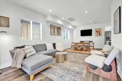 a living room with a couch and a table at Luxe Townhouse Near Downtown LA in Los Angeles