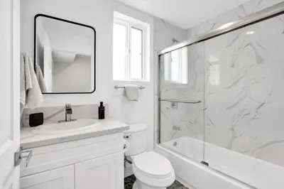 a white bathroom with a sink and a shower at Spectacular Rooftop View House in Los Angeles