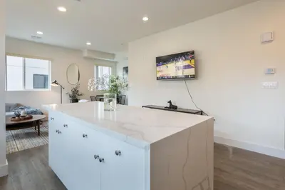 a kitchen with a large white island in a living room at Stylish DTLA Home With Views in Los Angeles