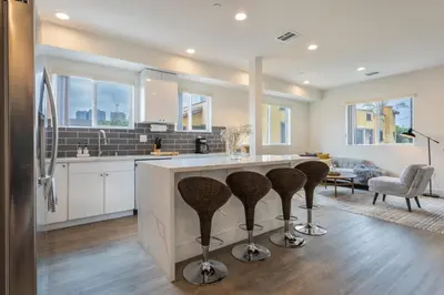 a kitchen with a large island with bar stools at Stylish DTLA Home With Views in Los Angeles