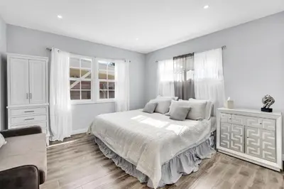 a white bedroom with a bed and a couch at Valley Ranch With Pool in Los Angeles