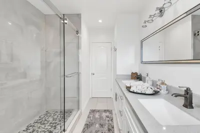 a white bathroom with a shower and a sink at Valley Ranch With Pool in Los Angeles