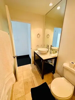 a bathroom with a sink and a toilet and a mirror at Cool Apartment in West Hollywood in Los Angeles