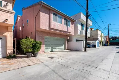an empty street with a house with a garage at House on the canal in Venice in Los Angeles