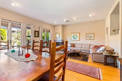 a living room with a table and a couch at House on the canal in Venice in Los Angeles