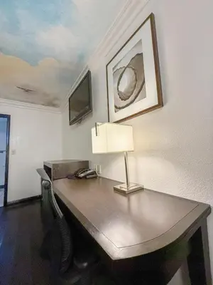 an office with a desk with a lamp on it at Super 7 Motel - Anaheim Packing District & Disneyland in Anaheim