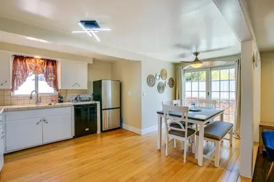 a kitchen and dining room with a table and chairs at 2 Mi to Ocean Long Beach Home with Gas Grill! in Long Beach