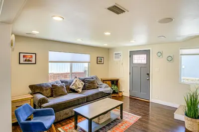 a living room with a couch and a table at 2 Mi to Ocean Long Beach Home with Gas Grill! in Long Beach
