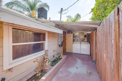 a small house with a washing machine in a yard at Walk to Dtwn Shops! Extended Stay Home in Burbank in Burbank