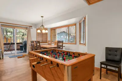 a living room with a foosball table at Arctic Wolf at Summit Base - 4 Bedroom log cabin at the base of Snow Summit in Big Bear Lake
