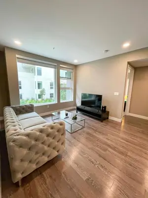 a living room with a couch and a television at Glamorous Getaway in Hollywood in Los Angeles