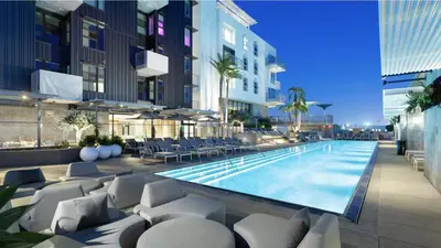 a swimming pool with lounge chairs and a building at Glamorous Getaway in Hollywood in Los Angeles