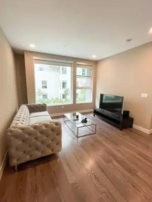a living room with a couch and a flat screen tv at Glamorous Getaway in Hollywood in Los Angeles