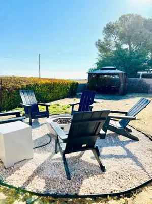 two chairs and a table and a fire pit at Silver Lakes Oasis with Resort Style Amenities in Helendale
